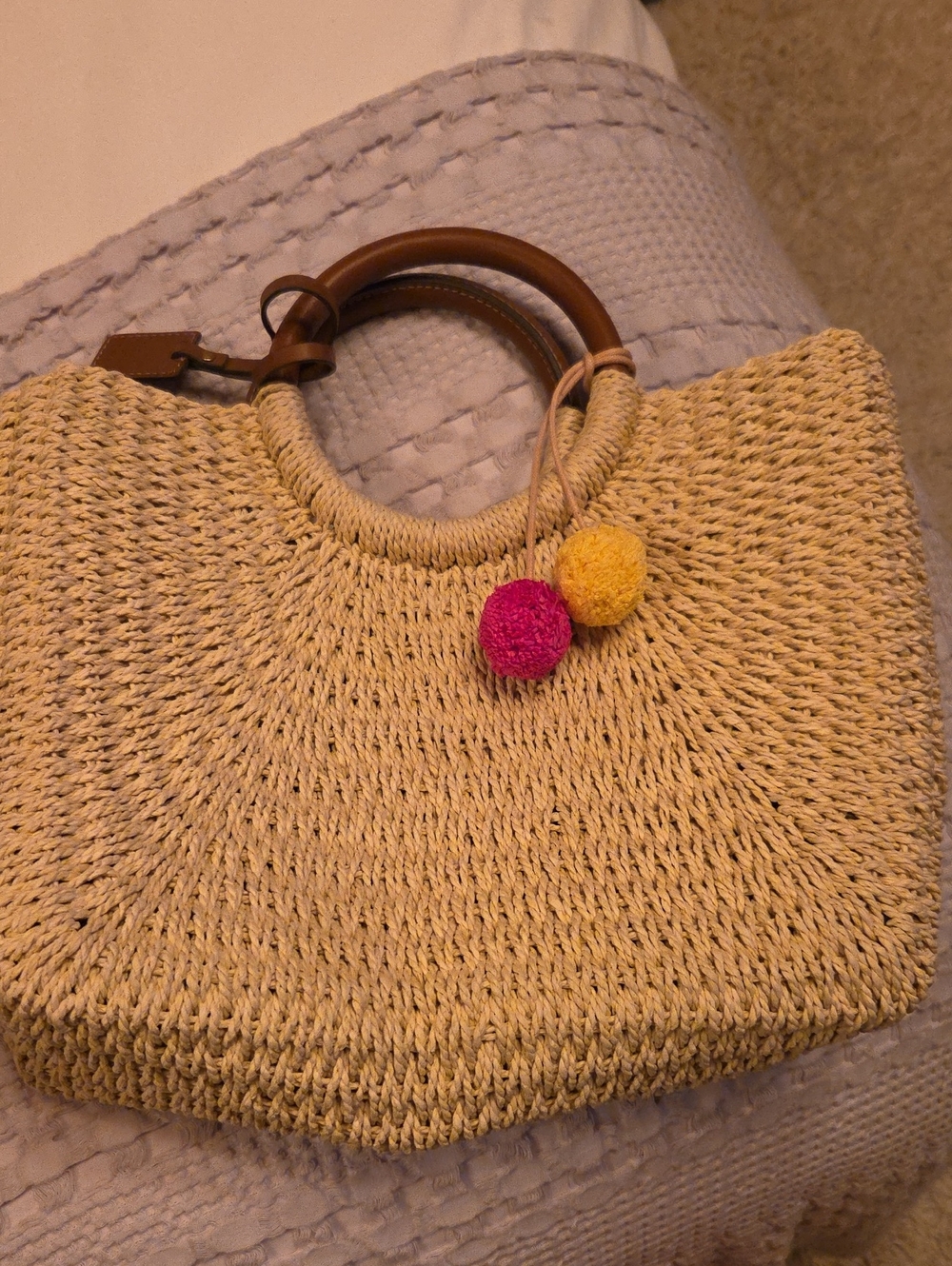 Fossil Beige Woven Tote with Brown Ring Handles and Pink & Yellow Pom Accents